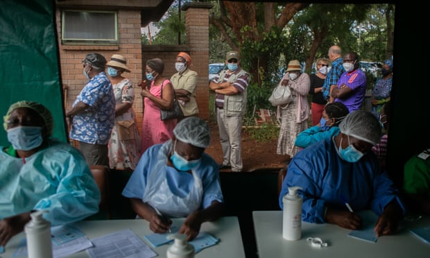 ‘Think of others’: elderly people in Zimbabwe dispel scepticism on Covid vaccine